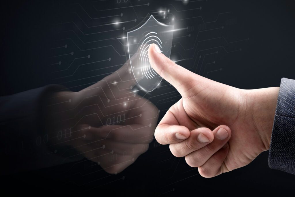 A person's thumb is pressing against a virtual fingerprint scanner, symbolizing security